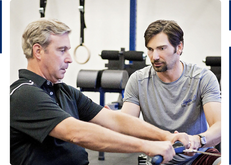 Two men working out with gym equipment in a fitness session