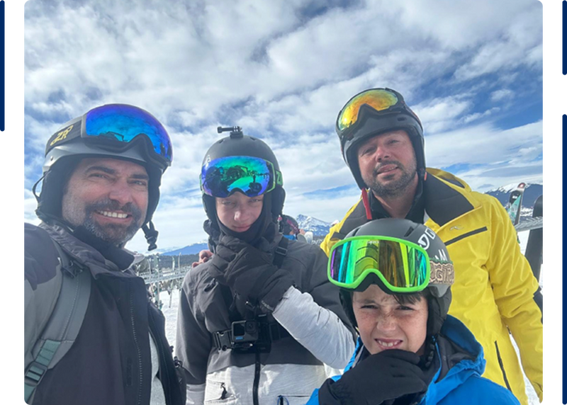 Four friends in ski gear on a mountain